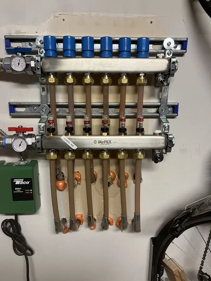 Plumber performing Water Heater Repair at a residential property in Mineola